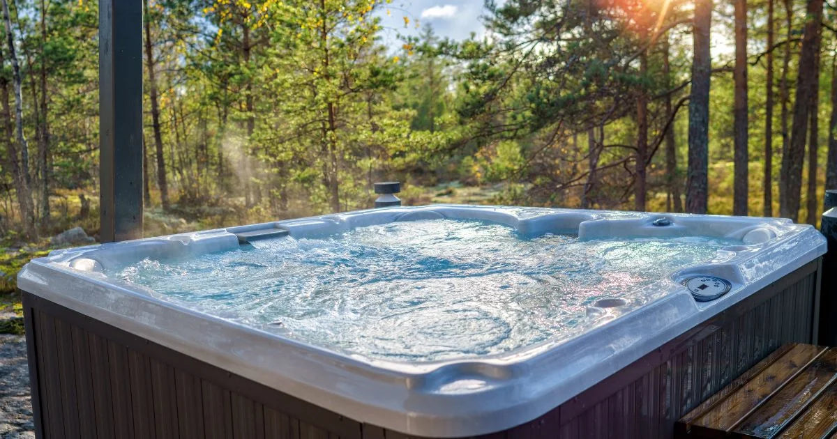 Outdoor hot tub with bubbling water set in a peaceful forest setting