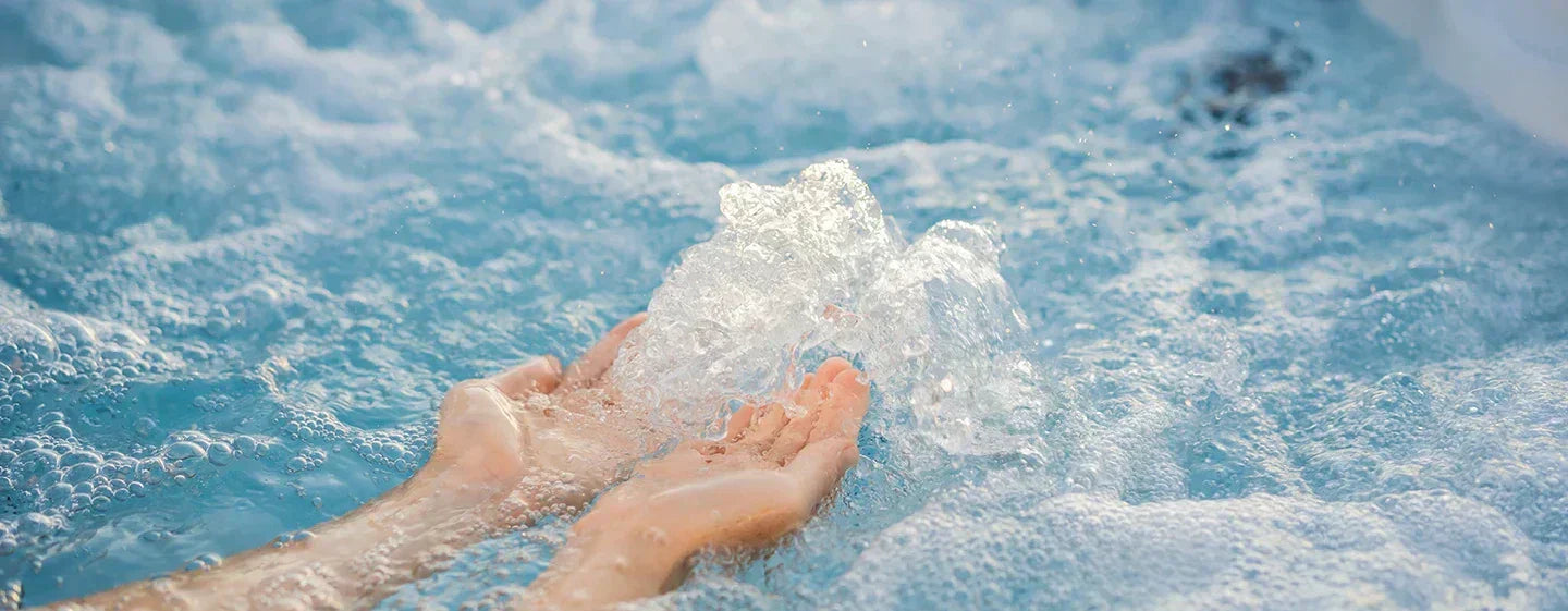 Hands in hot tub water